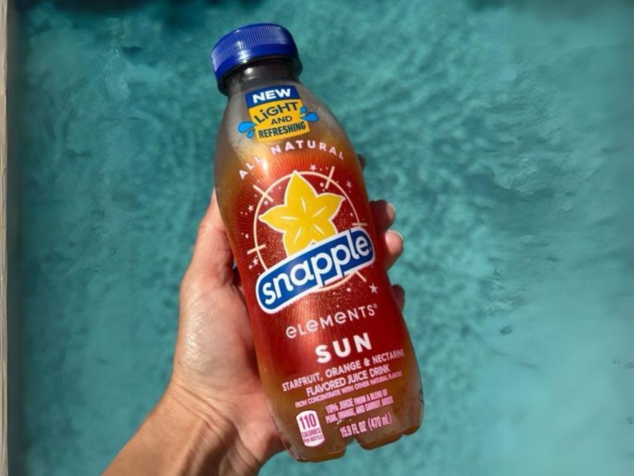 snapple elements sun drink being held over pool