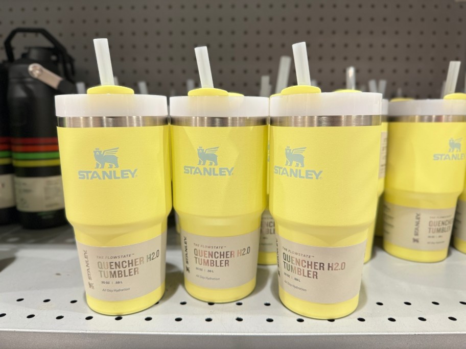 multiple light yellow Stanley FlowState Tumblers on shelf