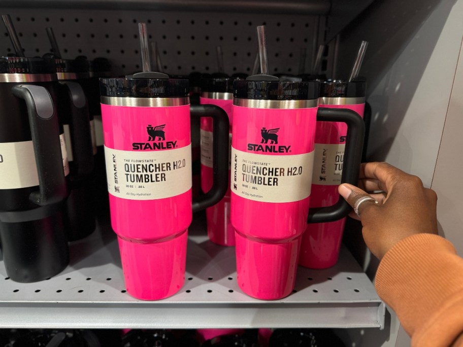 neon pink and black Stanley Tumblers on shelf