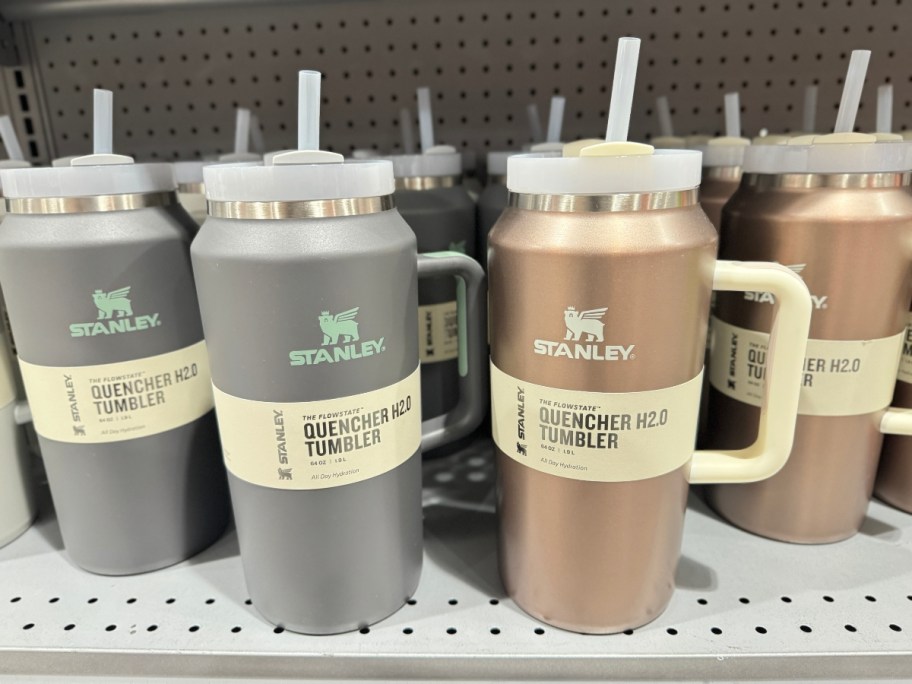 silver and rose gold Stanley 64 oz tumblers on shelf