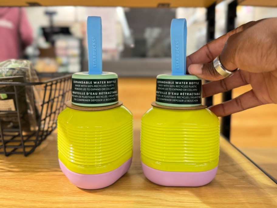 yellow and pink Starbucks collapsible water bottles on shelf