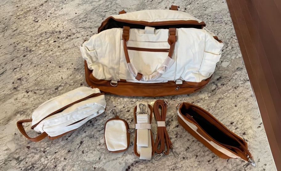 a travel duffle set with large carry-on with detachable strap, dopp kit, cosmetic bag and small zippered pouch. 