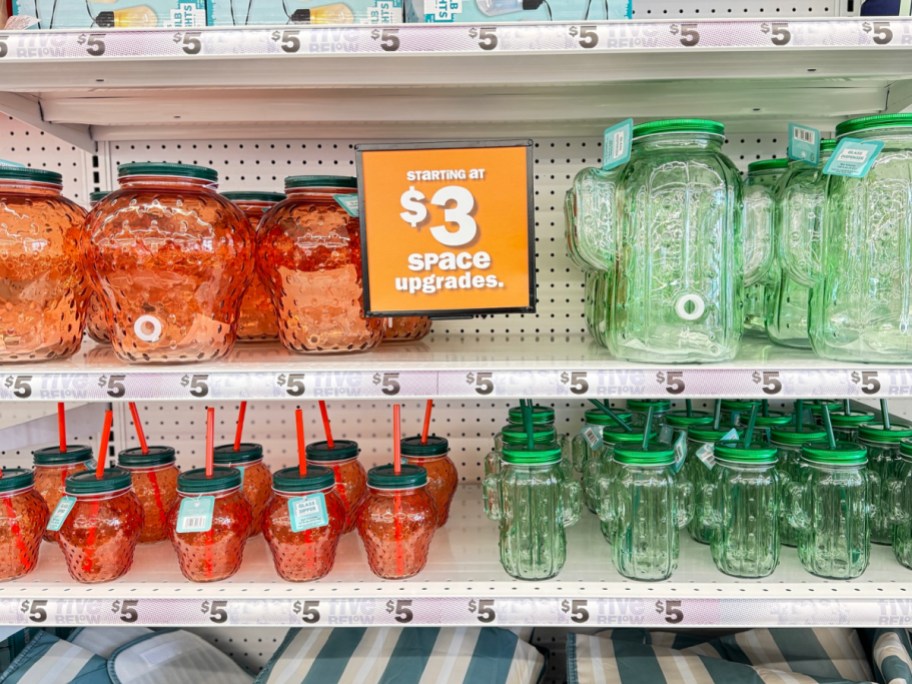 store display of glass dispensers and sippers in strawberry and cactus