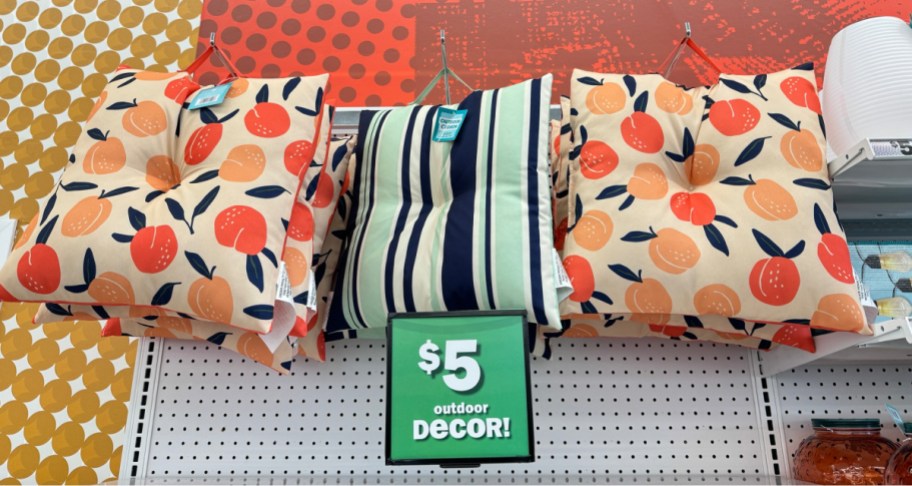 store display of outdoor cushions in orange and stripes with 5 price tag displayed