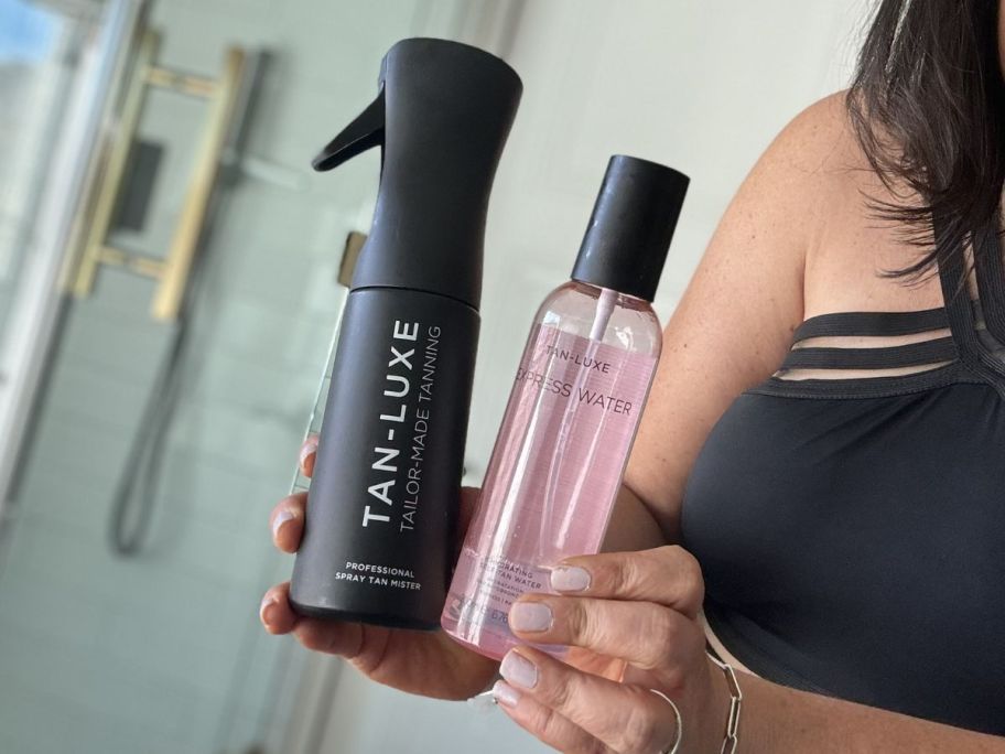 Tan-Luxe Express Water & Airbrush Professional Spray Tan Mister being held in bathroom by woman