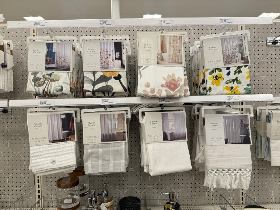 shower curtains in various prints and colors on display in Target