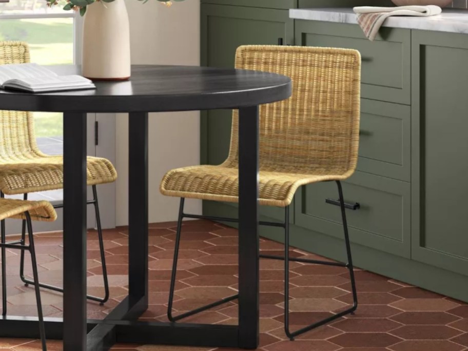 woven rattan looking and metal dining chair at a kitchen table