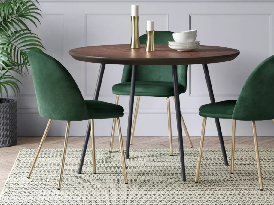 green velvet and gold dining chairs around a dining table
