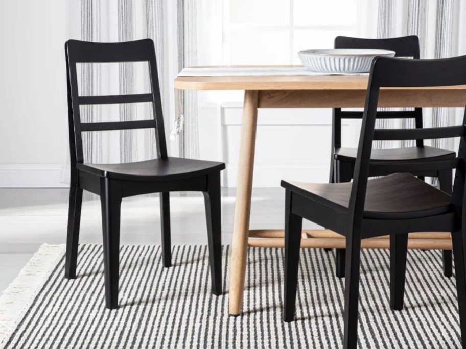 black ladder back dining chairs at a table