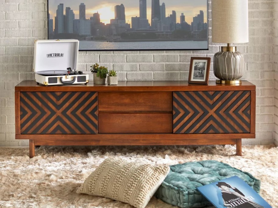 dark brown mid century modern large TV stand with inlay design in a living room