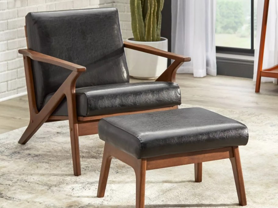 black leader and wood mid century modern chair with ottoman in a living room