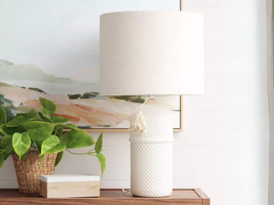 white ceramic large table lamp with white shade on a console table