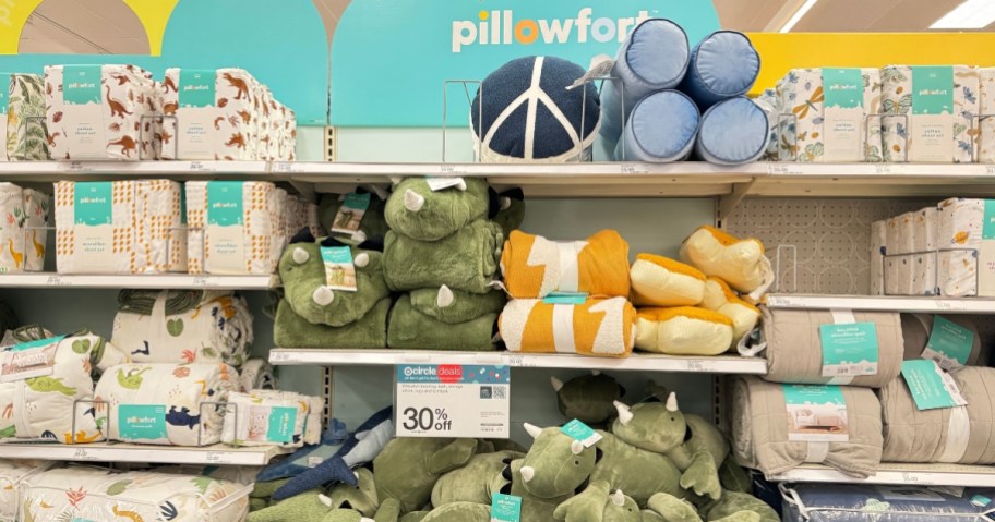 various Pillowfort plushes, pillows, sheets, blankets on display at Target