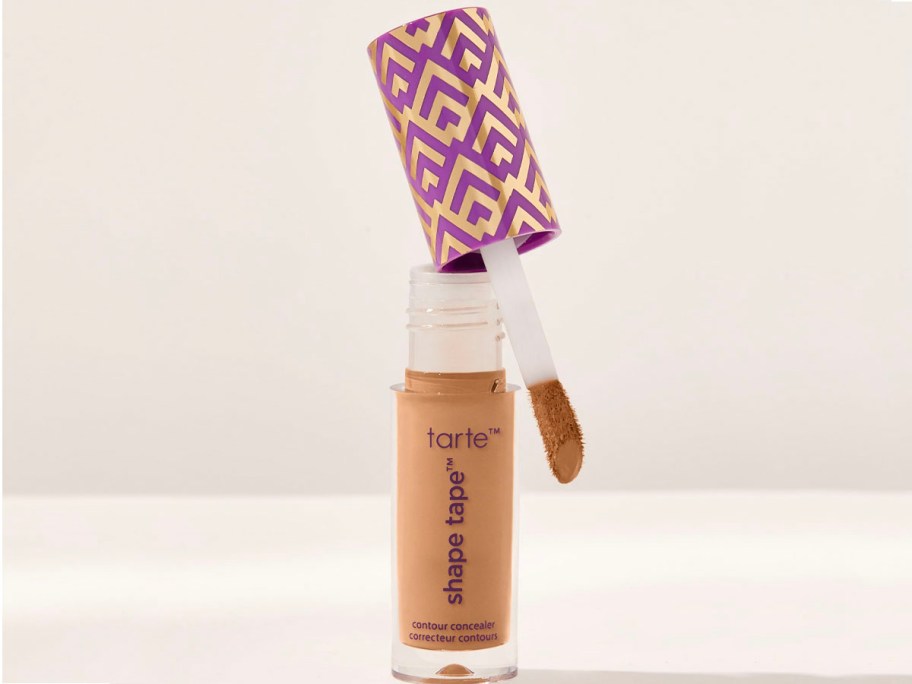 shape tape concealer open with brush sitting on top