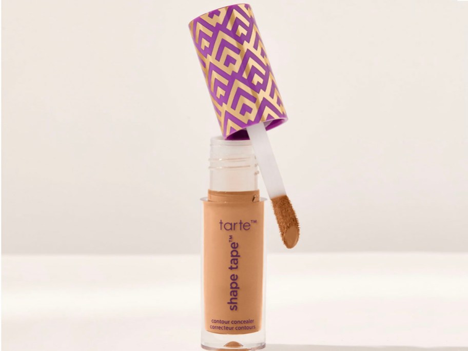 shape tape concealer open with brush sitting on top