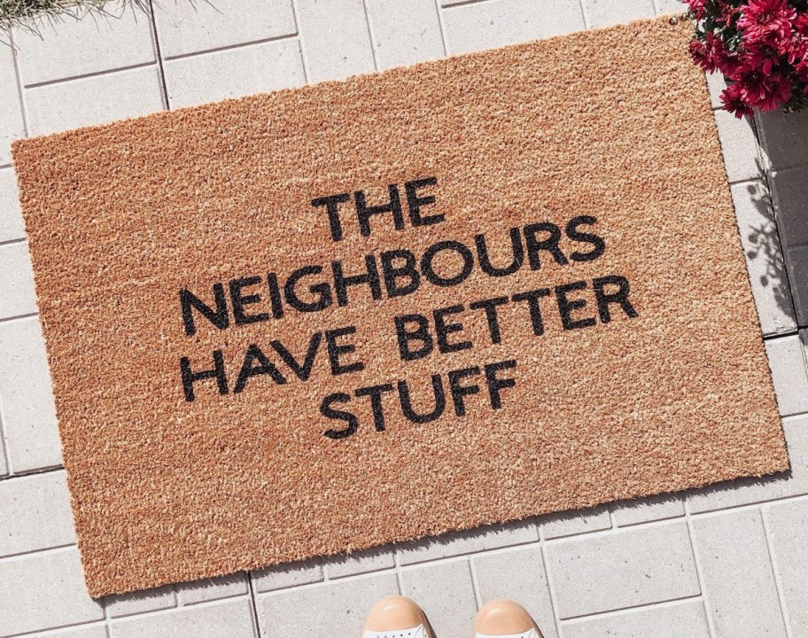the neighbours have better stuff doormat on paver patio