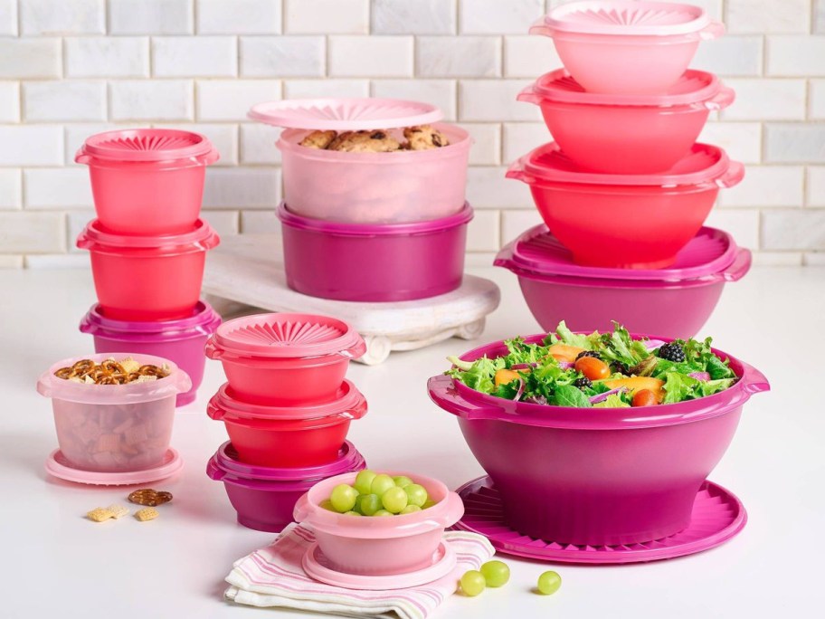 pink heritage collection tupperware stacked with food in them