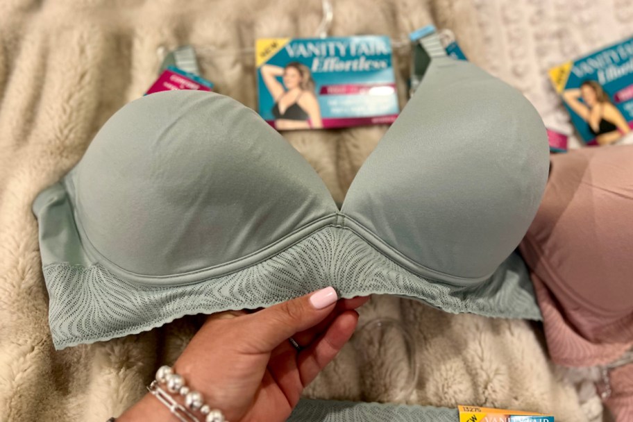 hand holding light teal bra 