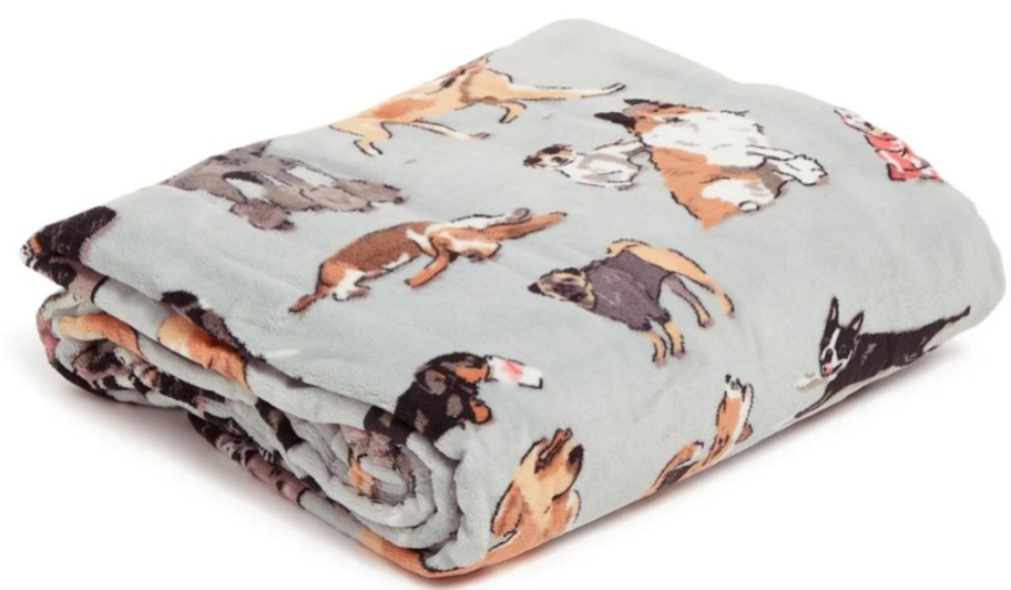 folded throw blanket with dogs on it