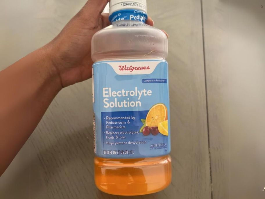 hand holding up walgreens electrolyte solution 
