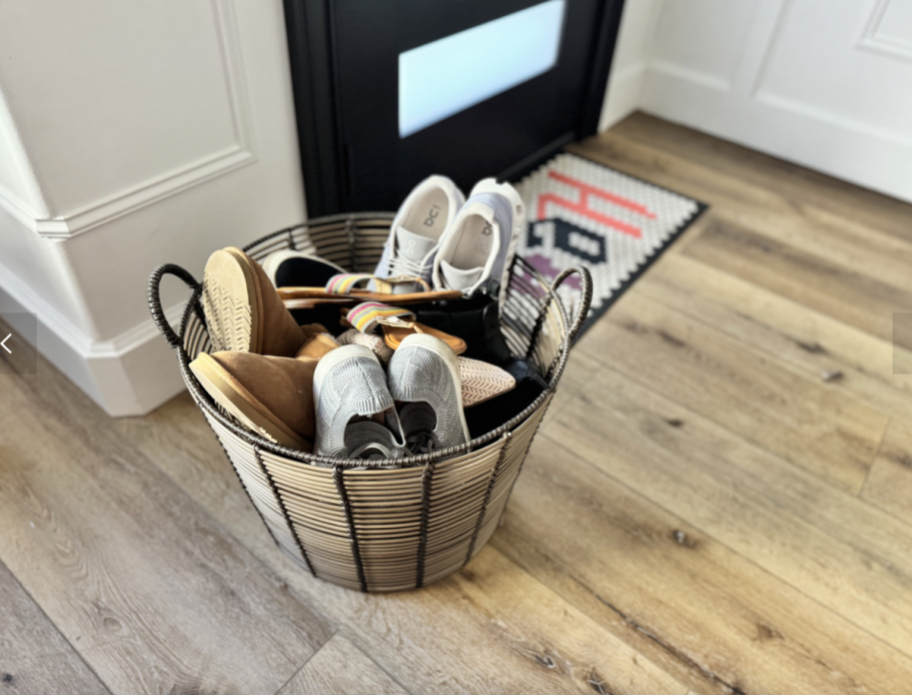 walmart basket with lots of shoes beside front door