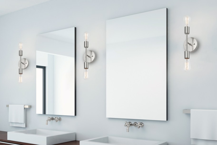 two bathroom mirrors with vertical wall sconces