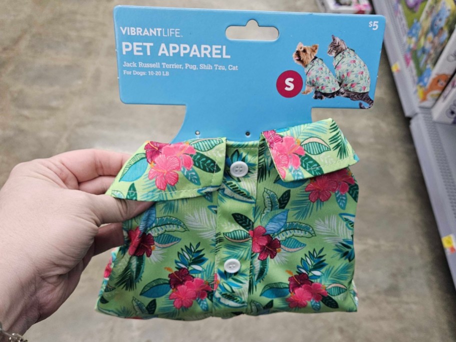 hand holding a Hawaiian flower print dog or cat shirt