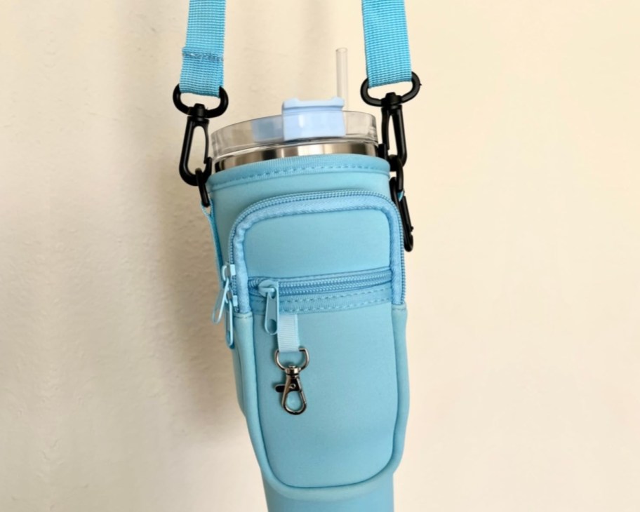 light blue water bottle bag holding tumbler