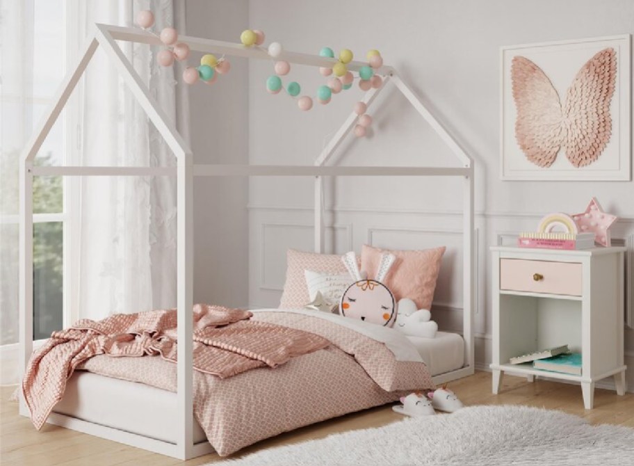 what toddler bed in a girl bedroom with rug and decorations