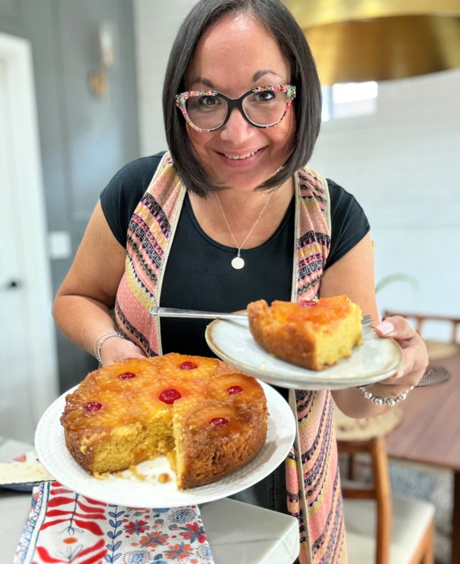 woman holding a plate with homemade pineapple upside down cake