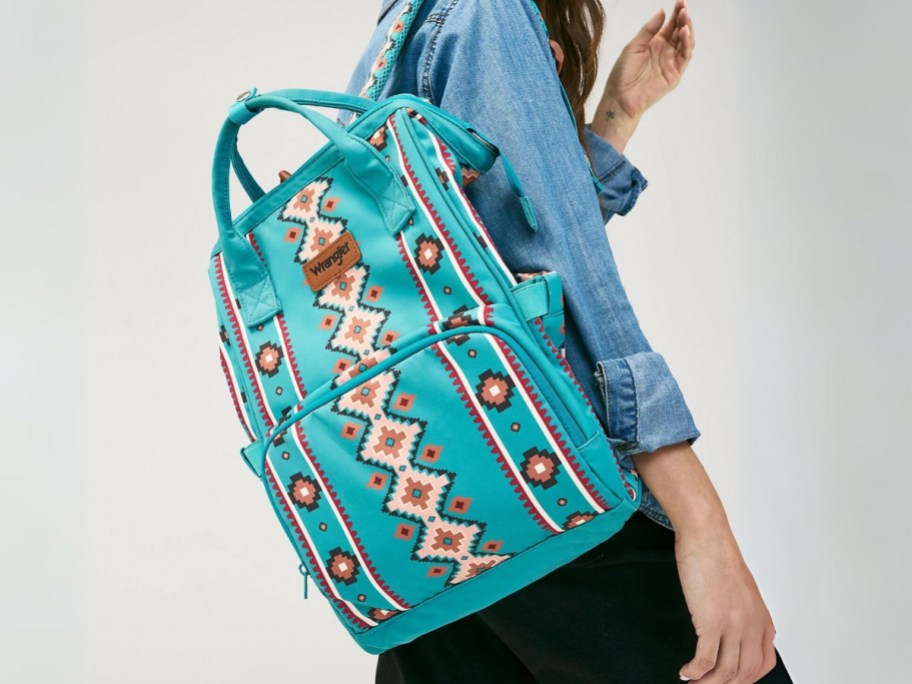 woman wearing a turquoise blue western print backpack