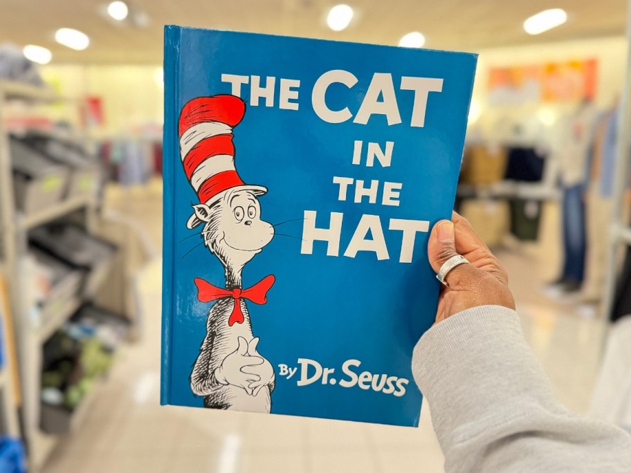 hand holding The Cat In The Hat Hardcover Book in a Kohl's store