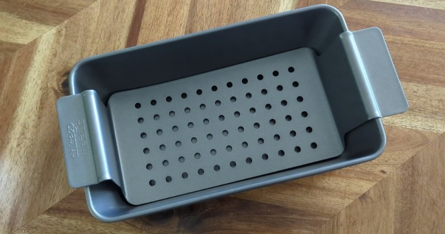 meatloaf pan with lifter piece on a kitchen table