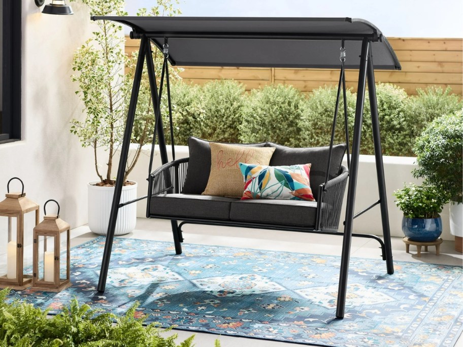 black metal outdoor swing with canopy
