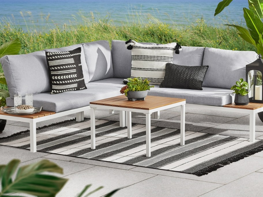white section outdoor patio set with grey cushions and coffee table