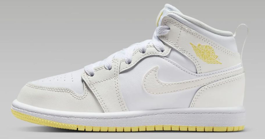white with yellow accents kid's Nike Jordan mid shoe