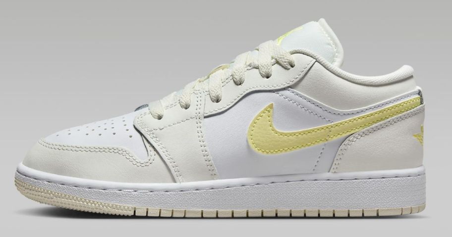 white and off white with yellow accents kid's Nike Jordan low shoe