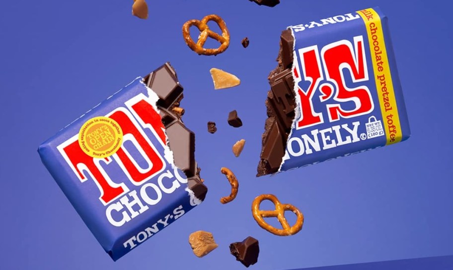 chocolate bar broken in half with toffee, chocolate, and pretzel pieces flying around