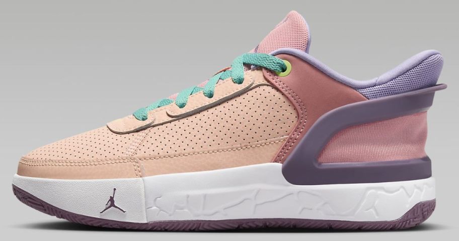 kid's Nike Jordan shoe in peachish pink with darker pink, purple and mint green accents