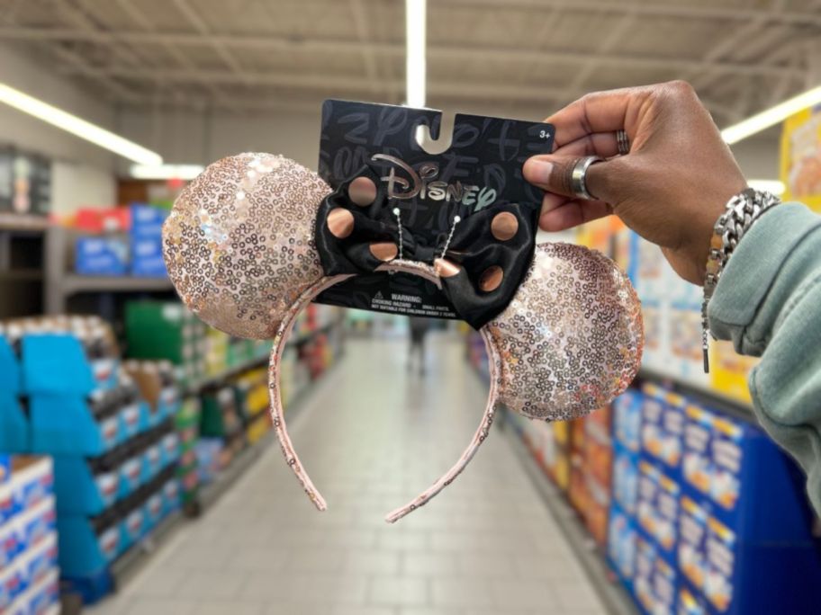 A person holding a pair of Aldi Disney Mickey Ears
