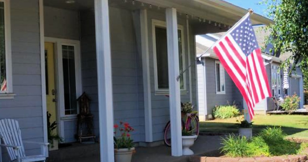 american flag flying outside home
