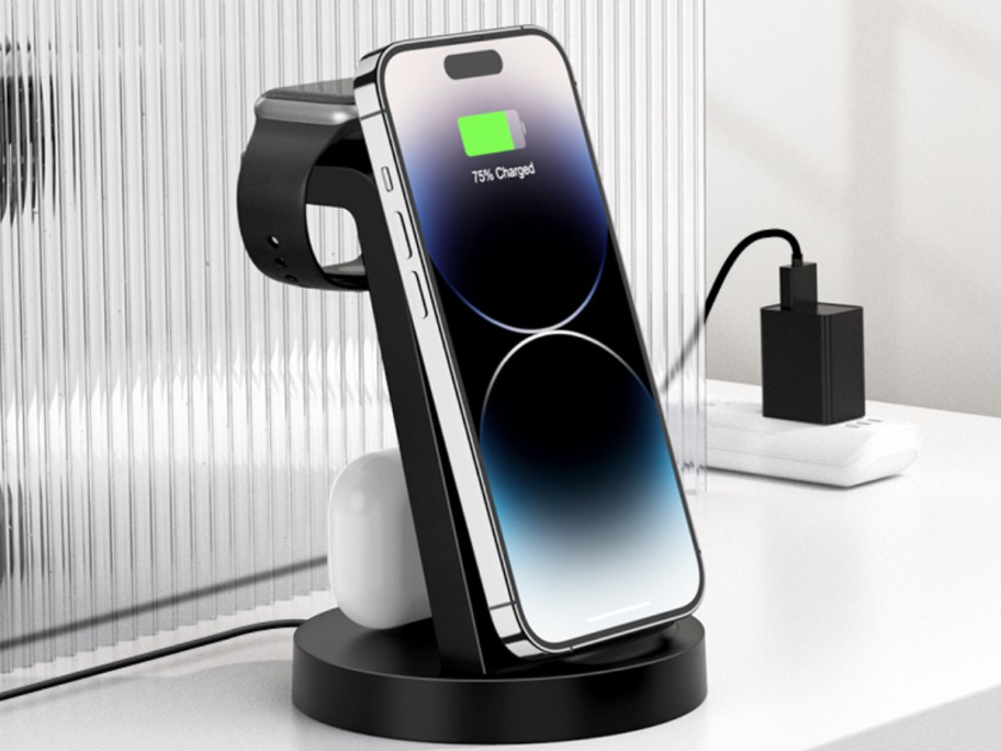 iphone, airpods, and apple watch on black charging station