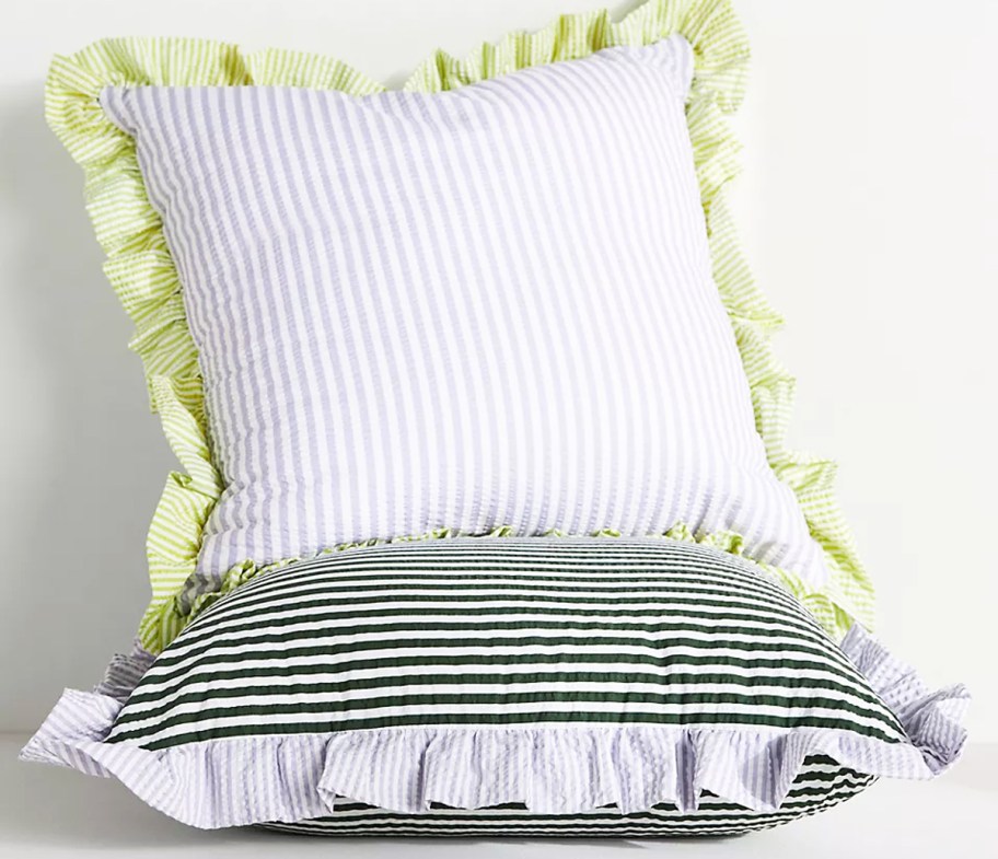 two striped pillows with ruffled edges