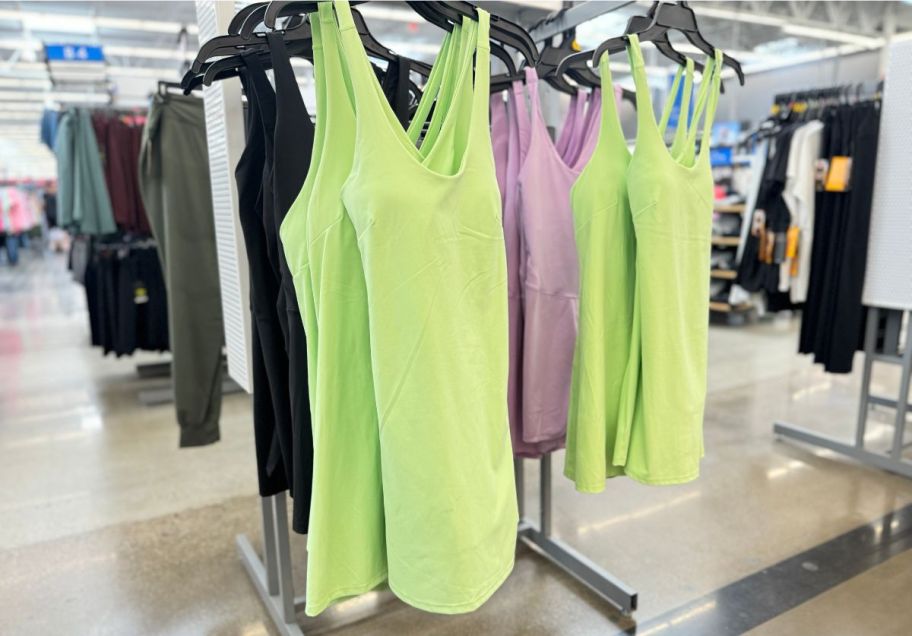 a green tank dress with built in shorts hanign on a rack in a walmart store