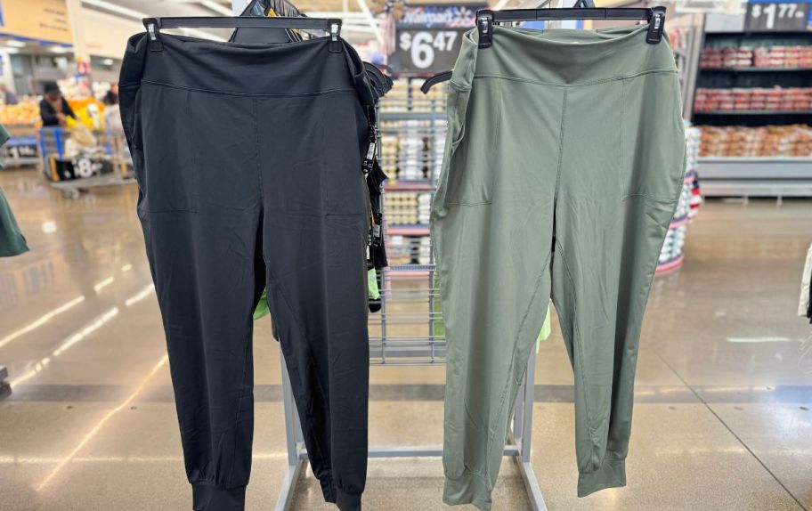 2 pair of jogger pants hanging on a rack in walmart