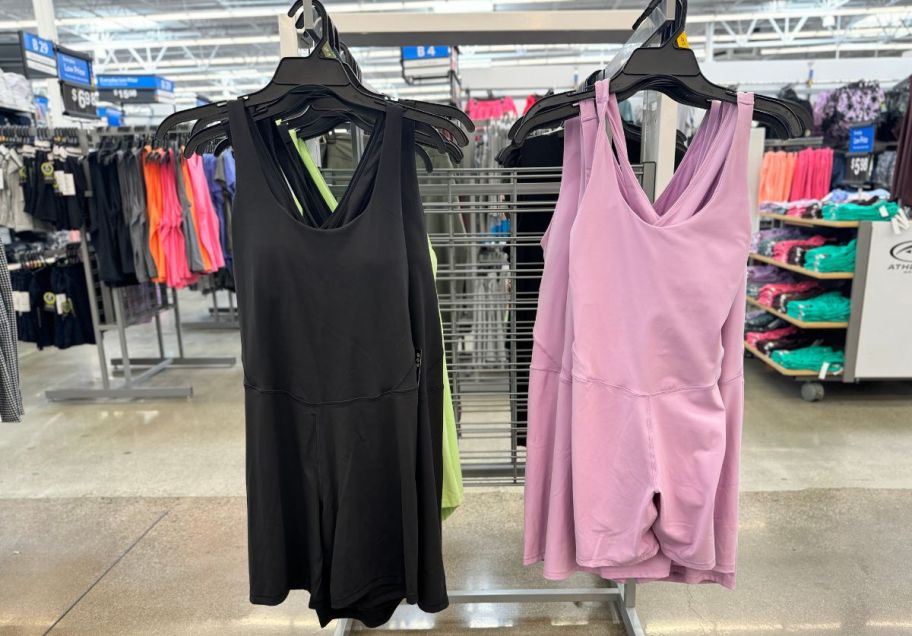 two performance rompers hanging on a clothing rack in a walmart store