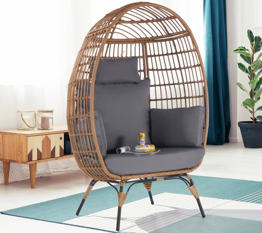 brown wicker egg chair with grey cushions