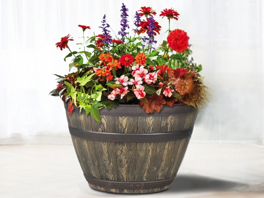 large whisky barrel planter with flowers in it
