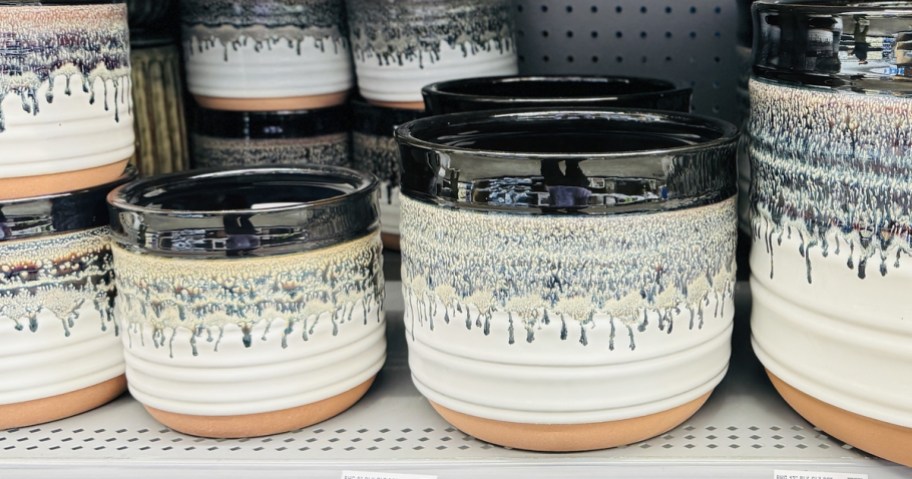 black and white ceramic planters on store shelf
