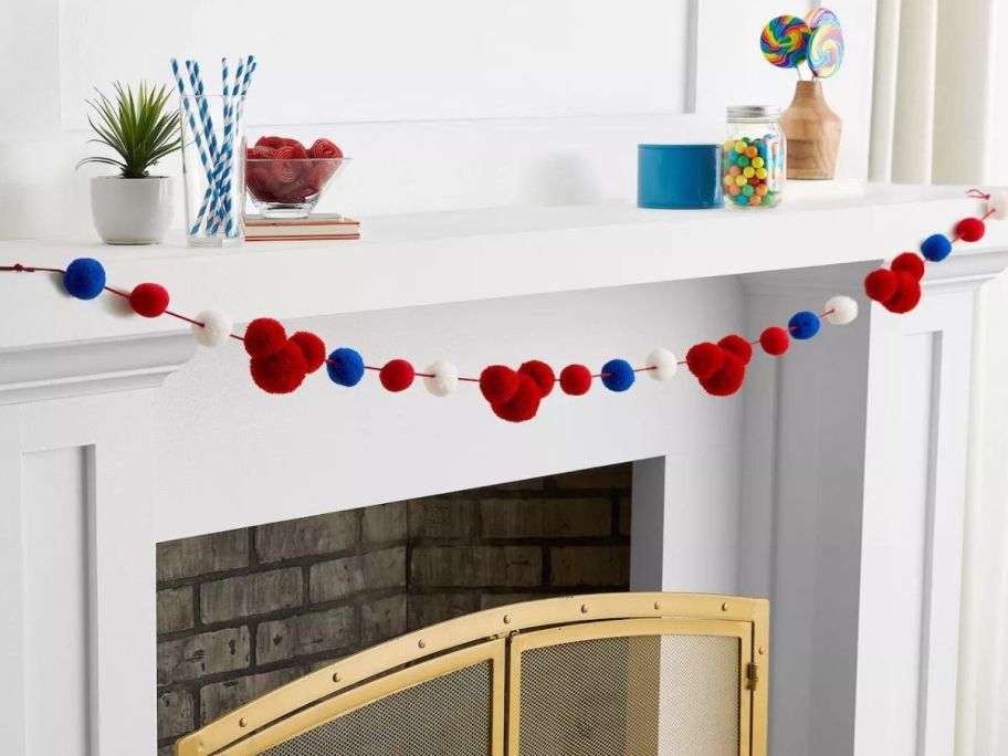 Mickey Americana PomPom Garland Hanging across a mantle